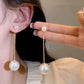 Orecchini lunghi con perle